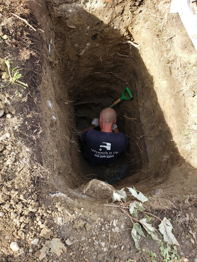 a plumbing expert is inspecting drains and pipes done by Wrench It Up plumbing and mechanical