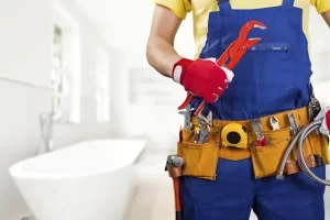 plumber with tools - Wrench It Up plumbing and mechanical